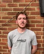 TP Smart Repairs technician, Owen, standing in front of a brick wall